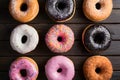 Assorted donuts displayed on kitchen table, tempting pastry delights