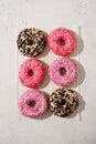 Assorted donuts pink and chocolate on white background