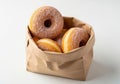 Assorted doughnuts in a brown paper bag sitting on a white surface Royalty Free Stock Photo