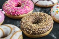 Assorted doughnuts in the glaze and colorful sprinkles Royalty Free Stock Photo