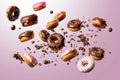 Assorted doughnuts with sprinkles on pink background Royalty Free Stock Photo