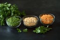 Assorted dried beans in glass bowls with fresh parsley, close-up view Royalty Free Stock Photo