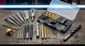 Assorted Drill Bits and Tools on Wooden Surface Royalty Free Stock Photo