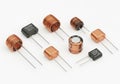 Assorted electronic inductors and capacitors with lead wires for circuit applications Royalty Free Stock Photo