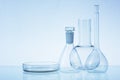 Assorted empty laboratory glassware, test-tubes. Blue tone medical background. Copy space Royalty Free Stock Photo