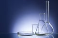 Assorted empty laboratory glassware, test-tubes. Blue tone medical background. Copy space Royalty Free Stock Photo