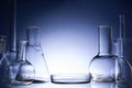 Assorted empty laboratory glassware, test-tubes. Blue tone medical background. Copy space Royalty Free Stock Photo