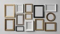 Assorted empty picture frames are arranged on a light gray wall Royalty Free Stock Photo