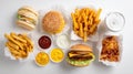 Assorted fast food items arranged on a white background Royalty Free Stock Photo
