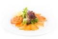 Assorted fish on a plate with lettuce and lemon on a white background. A plate of fish assorted isolated