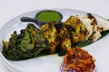 Assorted flavored tandoori chicken tikka, cream, saffron and spinach based marinated chicken cubes cooked in clay oven