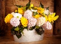 Assorted flowers in old metal pot Royalty Free Stock Photo