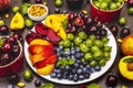 Assorted fresh berries of a cherry, gooseberry, blueberries, slices of ripe peach, plum and apricot, fragrant mint on a plate Royalty Free Stock Photo