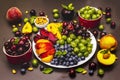 Assorted fresh berries of a cherry, gooseberry, blueberries, slices of ripe peach, plum and apricot, fragrant mint on a plate Royalty Free Stock Photo