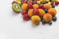 Assorted fresh berries and fruits. Apricots Kiwi Strawberry Cherry Blueberry on white