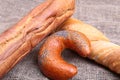 Assorted fresh breads isolated on old sackcloth. Royalty Free Stock Photo