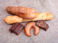 Assorted fresh breads isolated on old sackcloth. Royalty Free Stock Photo