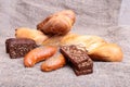 Assorted fresh breads isolated on old sackcloth. Royalty Free Stock Photo