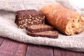 Assorted fresh breads isolated on old sackcloth. Royalty Free Stock Photo