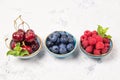 Assorted fresh juicy berries. Cherry, blueberry and raspberry in bowls