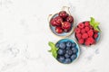 Assorted fresh juicy berries. Cherry, blueberry and raspberry in bowls, top view Royalty Free Stock Photo