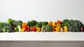 Assorted fresh vegetables arranged informally on white background with space for text