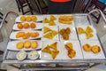 Assorted of fried dumplings and egg tarts on dimsum cart