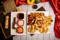 Assorted fried snacks platter with fried onion rings, shrimps, crackers, bq chicken wings, soy mayo dip sauce and black pepper Royalty Free Stock Photo