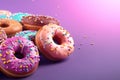 Assorted frosted donuts with colorful sprinkles against a purple background Royalty Free Stock Photo