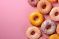 Assorted frosted donuts with sprinkles on a pink background Royalty Free Stock Photo