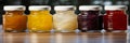 Assorted fruit jam jars with homemade preserves and jellies banner available for sale