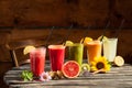 Assorted fruit smoothies on wooden background Royalty Free Stock Photo