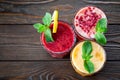 Assorted fruit smoothies on a wooden table Royalty Free Stock Photo