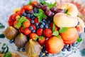 assorted fruits and berries on a plate. delicious and healthy vegetarian dessert Royalty Free Stock Photo