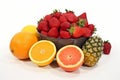 Assorted fruits organized in groups on clean white background for categorization Royalty Free Stock Photo