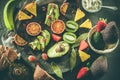 Assorted fruits on a plate. Avocados, blood oranges, kiwis, pineapple and strawberries