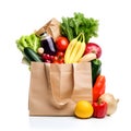 Assorted fruits and vegetables in brown grocery bag isolated over white background Royalty Free Stock Photo