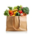 Assorted fruits and vegetables in brown grocery bag isolated over white background Royalty Free Stock Photo