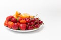 Assorted fruits in white bowl isolated on white background. Bowl of healthy fresh fruit. Top view. Strawberry, cherry, apricot. Royalty Free Stock Photo