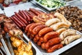 Assorted German sausages grilled in a steel container Royalty Free Stock Photo