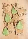 Assorted gingerbread cookies with frosting on wood board