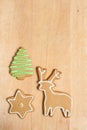 Assorted gingerbread cookies with frosting on wood board