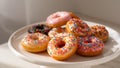 Assorted Glazed Donuts with Sprinkles on a White Pedestal, Culinary Still Life. Royalty Free Stock Photo