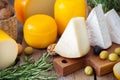 Assorted gourmet cheeses, olives, nuts and rosemary.