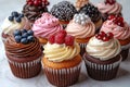 Assorted gourmet cupcakes with berries and elegant frosting. Royalty Free Stock Photo