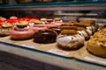 Assorted Gourmet Doughnuts on Display at bakery Royalty Free Stock Photo