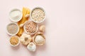 Assorted grains, pasta, and nuts in bowls on pastel background Royalty Free Stock Photo