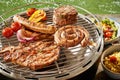 Assorted grilled meat on a gas barbecue
