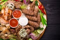 Assorted grilled meat and vegetables on rustic table Royalty Free Stock Photo