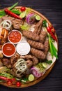 Assorted grilled meat and vegetables on rustic table